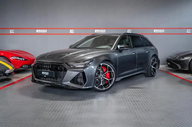 Audi RS6 Avant listing photo, front three-quarter view in a showroom